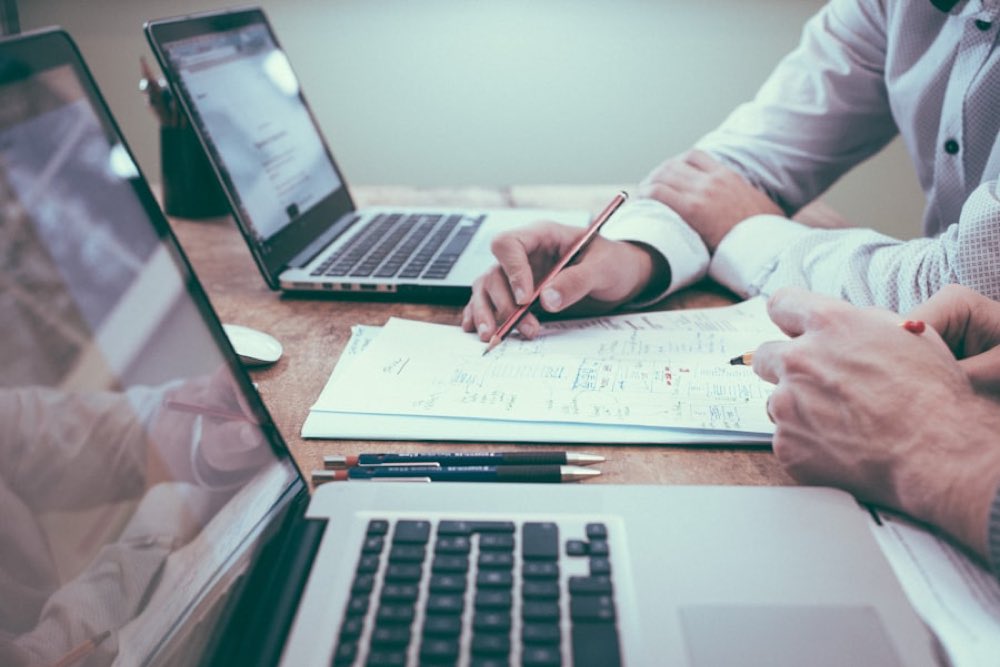 Advisors reviewing incorporation documents at a desk